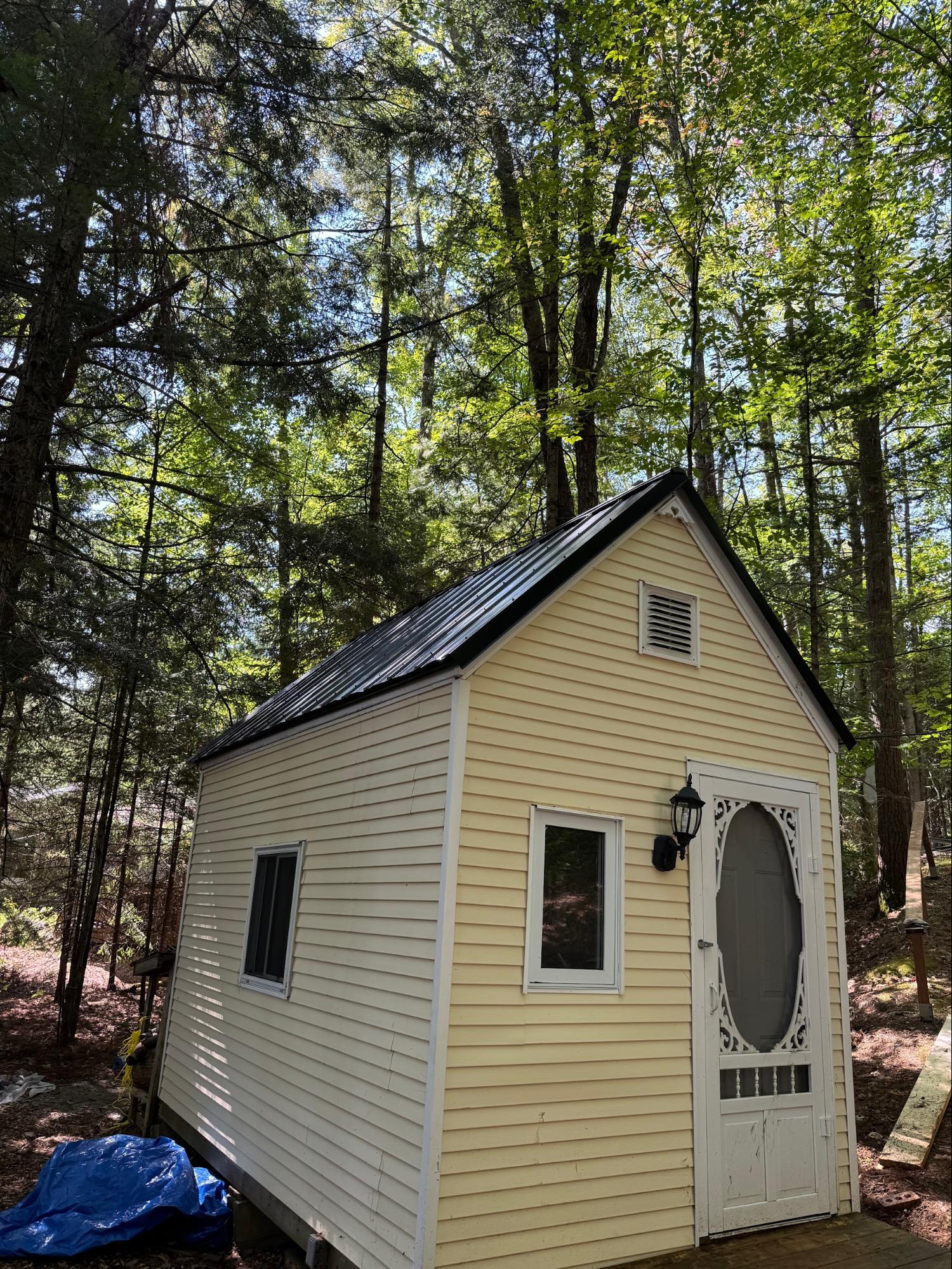 Bunkie with metal roof and exterior finishing