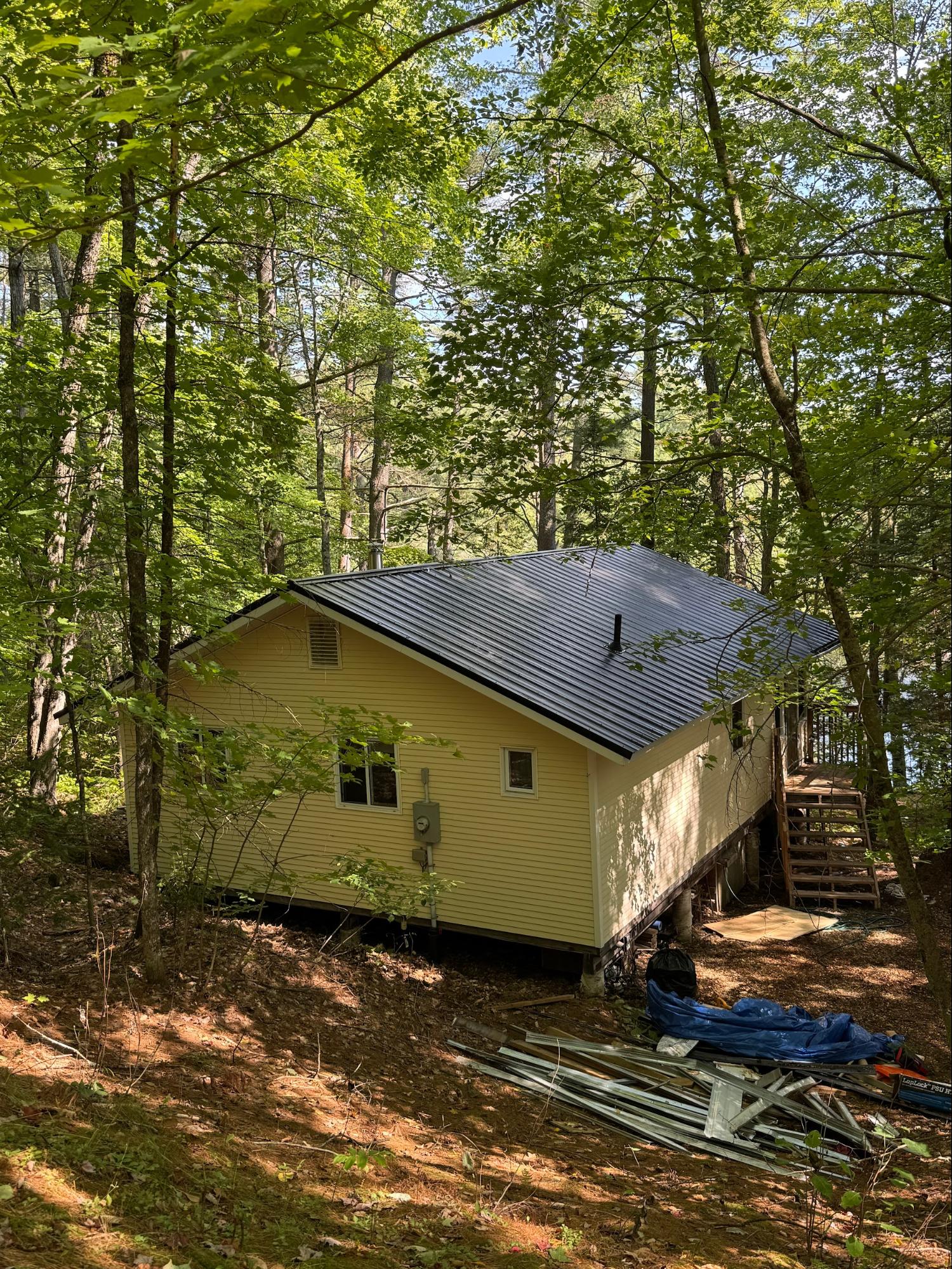 Cottage with completed metal roof