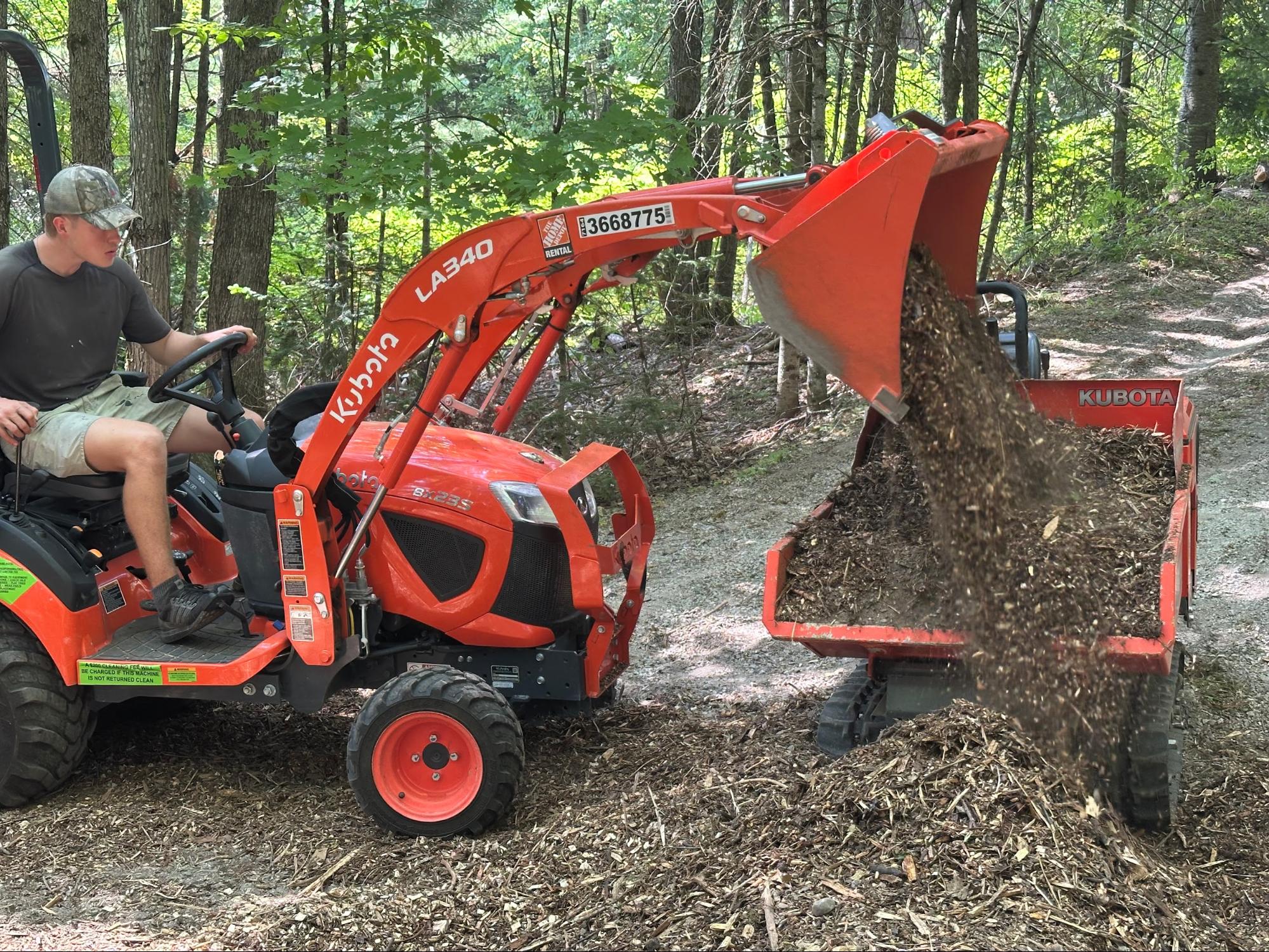Kubota tractor moving wood chips